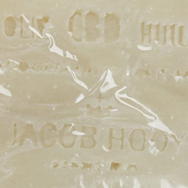 A close up of a Jacob Hooy CBD Soap bar with writing on it.