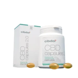 A white bottle and box labeled "10% CBD softgels capsules – Cibdol" with three yellow capsules in the foreground.