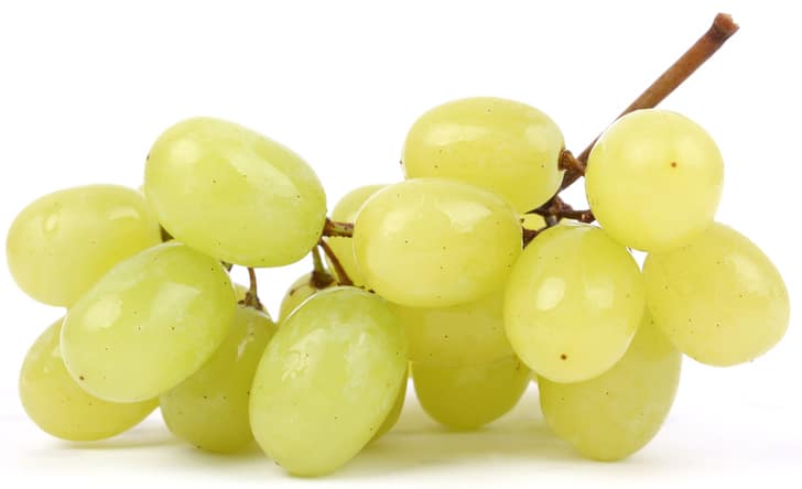 a bunch of green grapes on a white background.