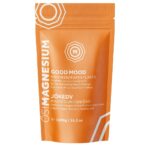 A 1000g orange and white pouch labeled "OsiMagnesium - Good Mood Magnesium Bath Flakes - Sweet Orange" with Sweet Orange essential oil. The text is in English and Hungarian.